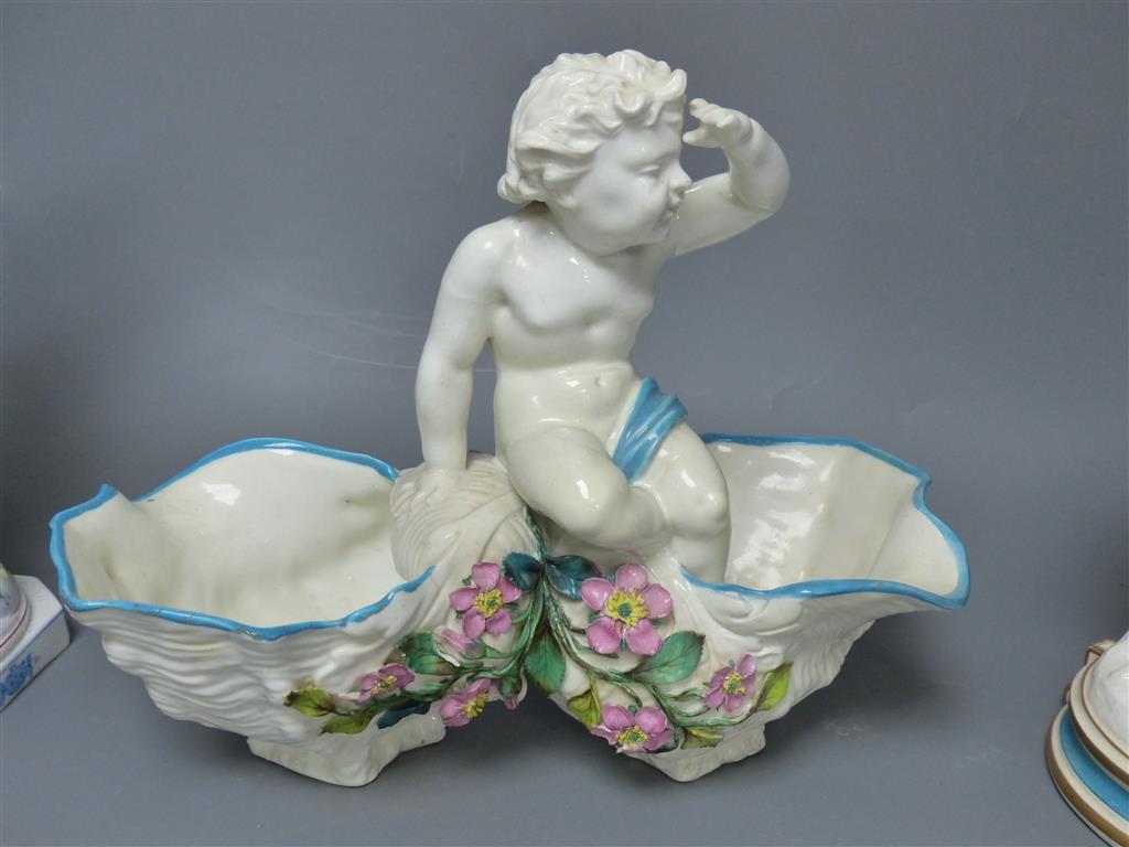 A large late 19th century French porcelain figure of Cupid, an English bone china cherub vase and a similar sweetmeat dish, tallest 3
